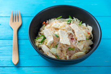 Thai pork sausage salad in black plate