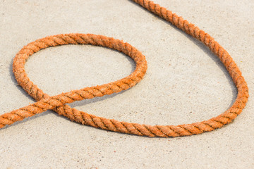 Orange rope on concrete in seaport