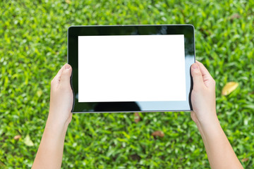 woman using tablet whilte sitting for relax in green park