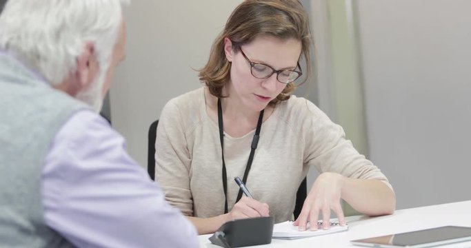 Female Medical Doctor taking a Senior patients blood pressure