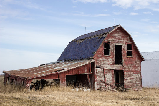 Old Red Barn. Abandoned early 1900's style wooden barn in the rural countryside of America's Midwest.