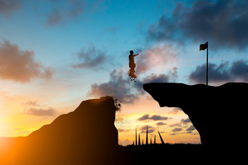 Silhouette businessman Work to achieve a leap forward with a good helper. team responsible for the idea of progress over blurred natural.Teamwork potential and motivate employee growth concept