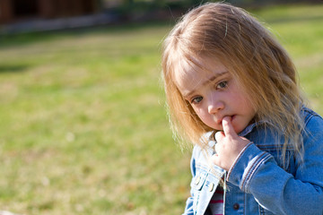 Beautiful Adorable Little Girl With Her Finger on Her Mouth