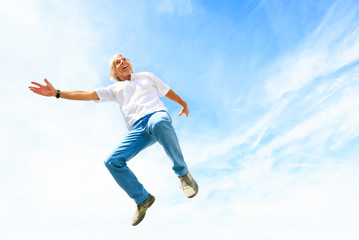 Fototapeta na wymiar Man In His 50s Jumping High