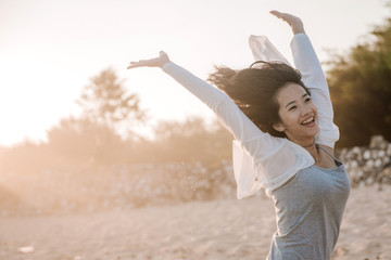 attractive asian woman enjoy at the beach