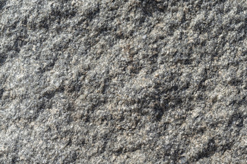 The rough surface of a granite piece of stone.