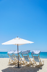 Beach chairs near the ocean background