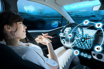 woman riding autonomous car. self driving vehicle. autopilot. automotive technology.