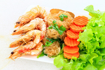 Shrimps with vermicelli served with fresh vegetables as a clean food.