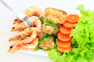 Shrimps with vermicelli served with fresh vegetables as a clean food.