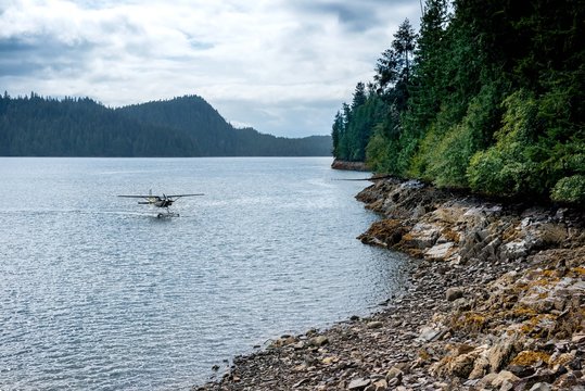 Small plane landing on lake