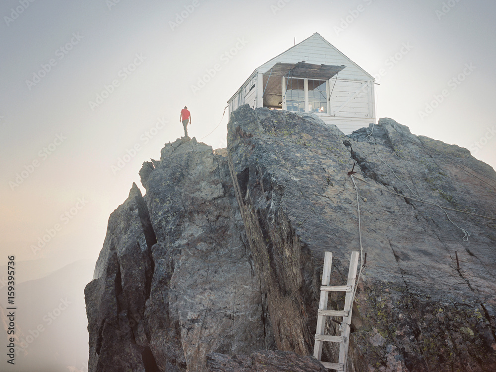 Wall mural man next to lookout on the top of the mountain