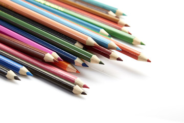 Many different colored pencils on white background