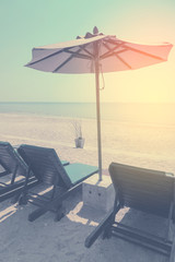 sunbeds and sunshade, Umbrella beach chair on the beach. summer vacation concept. vintage filter color