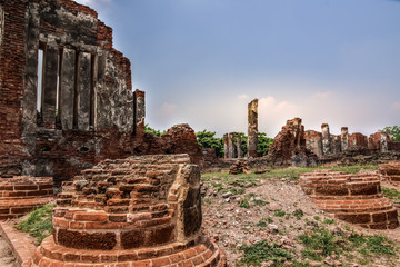 Wat Mahathat with Ruins of stupa and statue in the ancient Thai temple in Ayutthaya Historical Park.