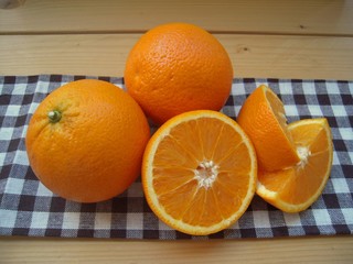 .Oranges closeup, cutaway, on a rustic table.......