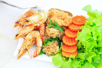Shrimps with vermicelli served with fresh vegetables as a clean food.