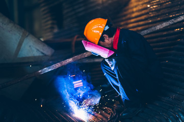 Worker doing electric welding,factory manufacturing,industry concepts.