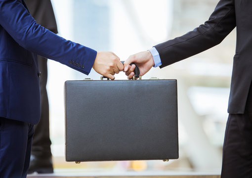 Business Transfer Deal. Handover Of A Suitcase In The Hands Of Partners.