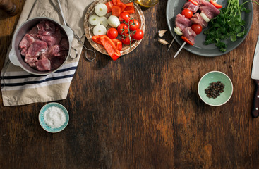 Fototapeta na wymiar Kitchen table with raw shish kebab and copy space