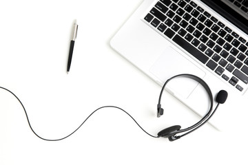 Microphone headset with notebook computer and pen on the table