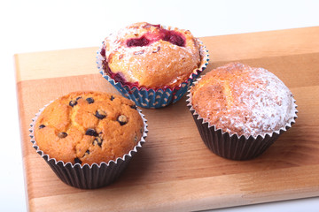 Homemade Blueberry muffins with powdered sugar and fresh berries.