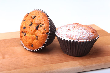 Homemade Blueberry muffins with powdered sugar and fresh berries.