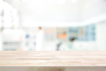 Fotobehang Empty wood counter top on blur pharmacy background © Atstock Productions