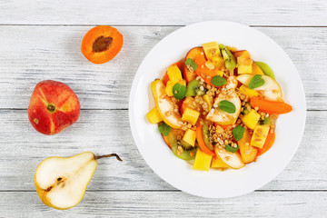 fruit salad  sprinkled with muesli on plate