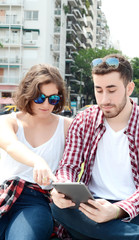 Couple using digital tablet.