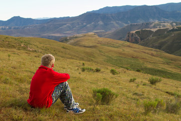 Fototapeta na wymiar boy praising and enjoying mountains and landscape