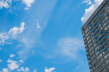 Fototapeta na wymiar Modern high-rise building made of glass against the sky