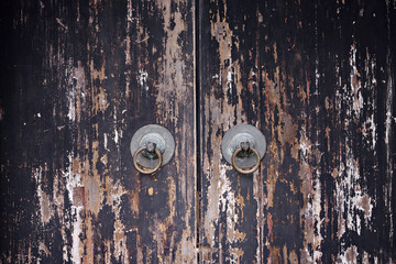 old shabby round handles of old wooden Chinese doors