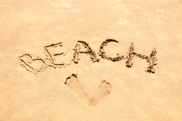 Inscription beach on the sand. Beach season. Rest on the sea