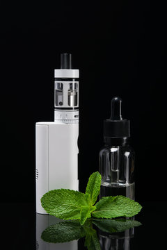 Set for vaping with mint aroma in bottles, on a dark background