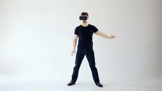 360 VR gaming concept, A man wearing VR headset moving his hands.