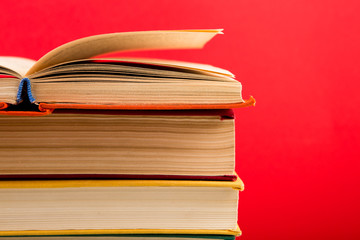 education and wisdom concept - open book on wooden table, color background