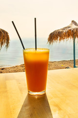Fresh orange juice on the beach