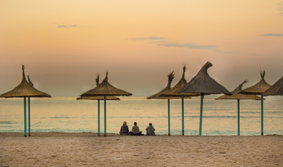 Sunset at the beach with people
