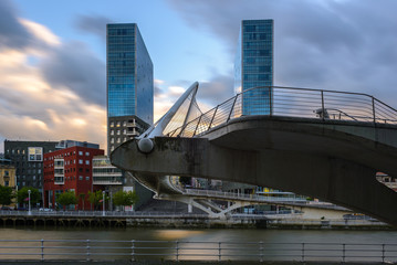 Fototapeta na wymiar Zubizuri Bridge and Isozaki Towers at sunset, Bilbao, Spain 