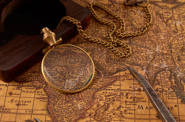 Fototapeta na wymiar Old vintage retro compass on ancient world map. Vintage still life. Travel geography navigation concept background.