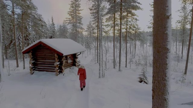 Woman tourist and sauna house in the beautiful Lapland landscape