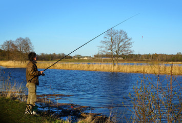 Fisherman on a coast of river
