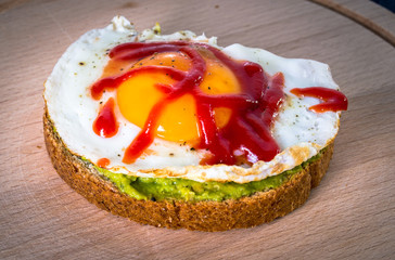 Toast delicious with avocado, egg, ketchup