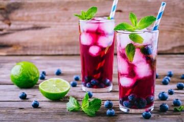 Blueberry ice lemonade with lime and mint in glasses