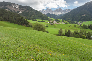 Fototapeta premium Small Italian mountain town in the Dolomites ( St. Magdalena in Val di Funes )