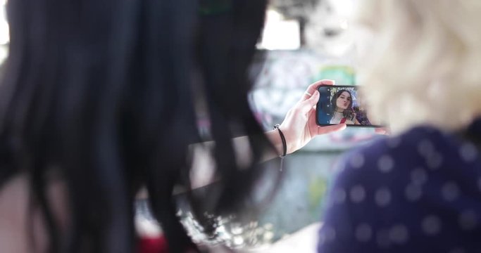 POV female friends taking selfie in urban city