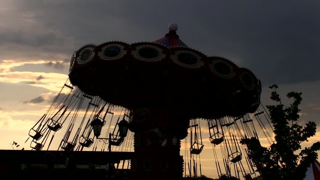 Rotating Carousel - silhouette against sunset
