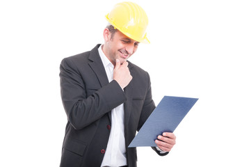 Portrait of contractor wearing hardhat holding clipboard