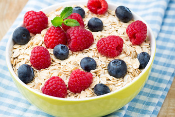 Oatmeal porridge with berries. Raspberries and blueberries.